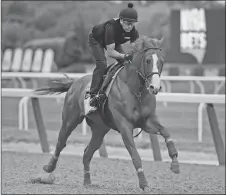  ?? AP PHOTO ?? Triple Crown hopeful Justify gallops around the track during a workout at Belmont Park in Elmont, N.Y., yesterday.