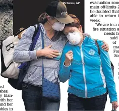  ?? Pictures / AP ?? Burned out homes, left, in the Coffey Park area of Santa Rosa. In Napa, Colby Clark of San Francisco, below left, comforts her mother, Bonnie Trexler.