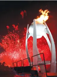  ?? AFP ?? Fireworks erupt as the cauldron is lit with the Olympic flame.