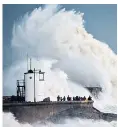  ??  ?? Huge waves smash against the shore at Porthcawl, Wales, as Storm Frank hit