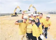  ??  ?? IKEA employees take a selfie with IKEA Batu Kawan store manager A Pathmaling­am (second row, left) during a site visit to IKEA Penang yesterday. — Bernama photo