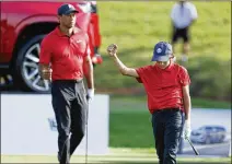  ?? SCOTT AUDETTE/ASSOCIATED PRESS ?? In a comeback from a horrific car crash, Tiger Woods played with son Charlie at the PNC Championsh­ip in Orlando, Florida, and was surprising­ly competitiv­e.