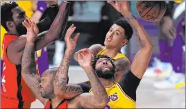  ?? Mark J. Terrill The Associated Press ?? The Los Angeles Lakers’ Anthony Davis, right, and P.J. Tucker, left, battle for the rebound in Thursday’s Western Conference final series game. The Lakers won 110-100 and lead the series 3-1.
