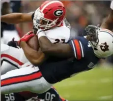  ?? BRYNN ANDERSON — THE ASSOCIATED PRESS ?? Georgia running back Nick Chubb is tackled by Auburn linebacker Jeff Holland during the first half on Saturday Auburn, Ala. in