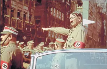  ??  ?? Hitler receives the salute of the columns at a rally in Nuremberg, Germany, in 1938