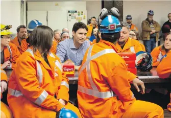  ?? TARA WALTON, THE CANADIAN PRESS ?? Prime Minister Justin Trudeau speaks with workers during a visit to the Stelco steel plant in Hamilton.