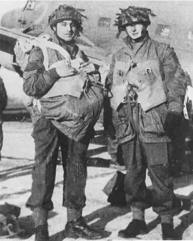  ??  ?? Two Canadian paratroope­rs prepare to depart for Normandy, France, in June 1944.