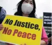  ??  ?? A SOUTH Korean activist holds a placard during a rally near the US embassy in Seoul yesterday. | EPA-EFE