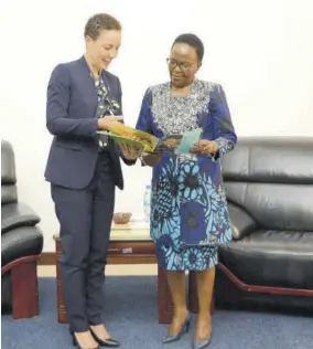  ?? ?? Senator Kamina Johnson Smith (left) presents Foreign Minister of Tanzania Liberata Mulamula with a copy of her cadidature statement.