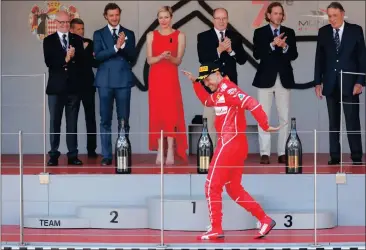  ?? Picture: FRANK AUGSTEIN, AP ?? SHAKE, RATTLE AND ROLL: Sebastian Vettel celebrates on the podium after winning the Monaco Grand Prix yesterday.
