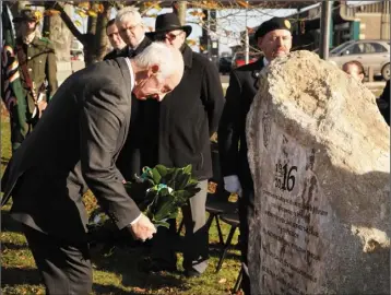  ??  ?? Terry McCann lays a wreath