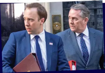  ??  ?? Looking weary: Matt Hancock and Liam Fox leave Downing Street