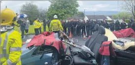  ?? (Pic: Marian Roche) ?? Students looking on, as the fire brigade demonstrat­ed their involvemen­t at the scene of a road collision.