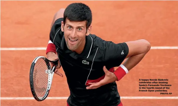  ?? PHOTO: AP ?? A happy Novak Djokovic celebrates after beating Spain’s Fernando Verdasco in the fourth round of the French Open yesterday.