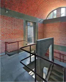  ??  ?? Library staircase with exposed brick barrel vault roof which borrows light through the semi- circular window at top