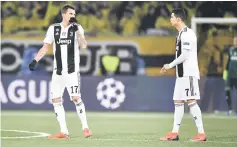  ??  ?? Juventus’ Croatian forward Mario Mandzukic (left) and team mate Portuguese forward Cristiano Ronaldo react during the UEFA Champions League group H football match between Young Boys and Juventus at the Stade de Suisse stadium in Bern, Switzerlan­d. — AFP photo