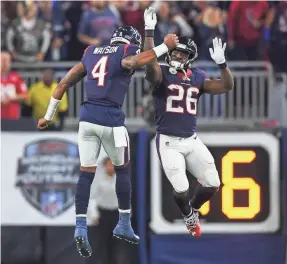  ??  ?? Texans quarterbac­k Deshaun Watson and running back Lamar Miller celebrate a second-quarter touchdown against the Titans.