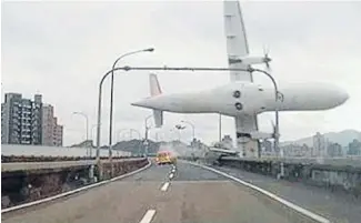  ??  ?? What the? Footage taken from the dashboard camera of a car shows the stricken plane clipping an overpass before crashing into the Keelung River in Taipei.