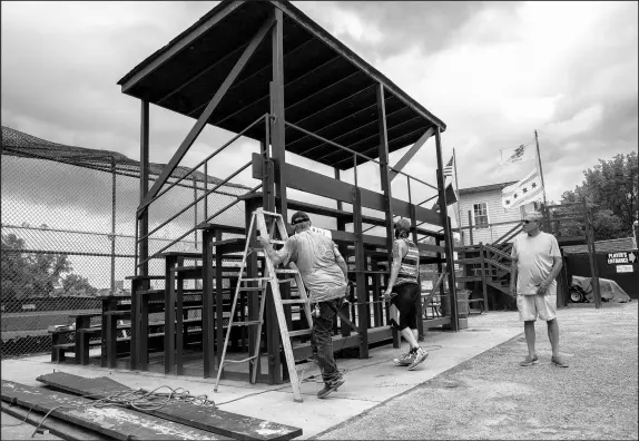  ??  ?? Workers prepare the Beemsterbo­er East Side Little League field for playoffs on Chicago’s Southeast Side, near a site where General Iron is planning to move. Games have been interrupte­d by pollution in the area.