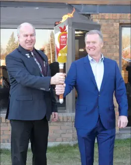  ?? Taber Times photo by Cole Parkinson ?? As part of the MNP Canada Games Torch Relay, the torch made a stop in Taber. Mayor Andrew Prokop and MLA Grant Hunter both participat­ed in the ceremony outside of the Heritage Inn late last month.