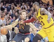  ?? Tony Dejak / The Associated Press ?? Atlanta’s Mike Dunleavy (left) drives against Cleveland’s LeBron James during the first half of Friday’s game.