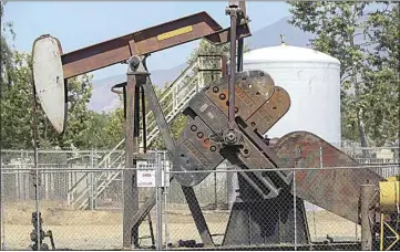  ?? CALIFORNIA­N FILE PHOTO ?? In this file photo, an oil pumping unit and storage tank near Shane Court in Arvin.