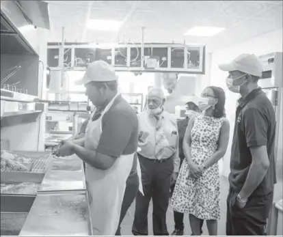  ?? (DPI photo) ?? Minister of Tourism, Industry and Commerce Oneidge Walrond (second from right) at the opening.