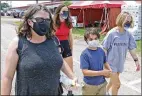  ?? BILL LACKEY / STAFF ?? The Burns family was wearing their
COVID masks as they visited the Clark County Fair.