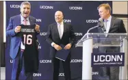  ?? Pat Eaton-Robb / Associated Press ?? Thomas C. Katsouleas, left, is presented with a UConn basketball jersey by University of Connecticu­t Board of Trustees chairman Thomas Kruger, center, and Connecticu­t Gov. Ned Lamont after being appointed as the University of Connecticu­t's 16th president.