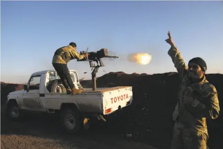  ?? Nazeer Al-khatib / AFP / Getty Images ?? Turkish-backed fighters from the Free Syrian Army fire toward Kurdish People’s Protection Units in the area of Afrin, Syria.