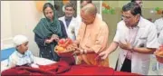  ?? SOURCED ?? Chief minister Yogi Adityanath giving a fruit hamper to a child patient at BRD Medical College in Gorakhpur on Saturday.