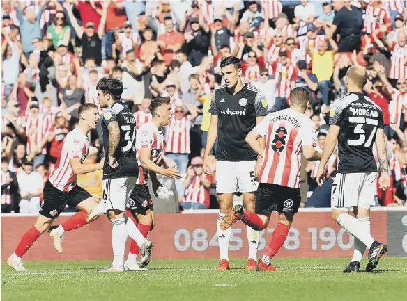  ??  ?? Celebratio­ns after Dan Neil put Sunderland in front. Pictures: Frank Reid and Martin Swinney.