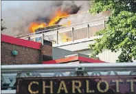  ?? BRIAN MCINNIS/THE GUARDIAN ?? Smoke and flame pour from the top floor of the old YMCA building in Charlottet­own Friday afternoon. Tenants were forced to flee as the flames and smoke spread.