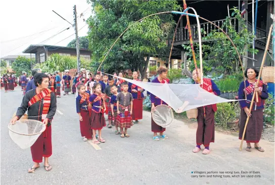  ??  ??      Villagers perform hae klong tum. Each of them carr y farm and fishing tools, which are used daily.