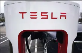  ?? ASSOCIATED PRESS FILE PHOTO ?? Tesla Supercharg­er is seen at Willow Festival shopping plaza parking lot in Northbrook, Ill., on May 5.