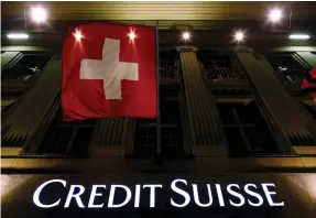  ?? (Ruben Sprich/Reuters) ?? THE CREDIT SUISSE logo is seen below the Swiss national flag at a building in Bern, Switzerlan­d. The Swiss bank’s initiative is part of a wider drive by investment banks to soften their workaholic image and stop talented staff leaving for jobs in other...