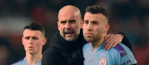  ?? AFP ?? Che futuro? Pep Guardiola, 49 anni, tecnico del Manchester City, qui con Nicolas Otamendi, 32