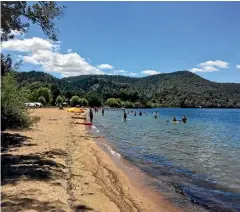  ??  ?? The beach at Lake O¯ kareka is a popular swimming spot.