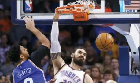  ?? THE ASSOCIATED PRESS FILE ?? Jahlil Okafor, shown here getting dunked on by Oklahoma City Thunder center Steven Adams (12), the defensive end of the court or the No. 3 pick in the 2015 draft will hear it from the boo birds. can’t take time off at