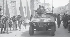  ?? Harouna Traore
Associated Press ?? FRENCH TROOPS patrol a street in Timbuktu. Paris says it went to Mali’s aid to prevent the rise of a terrorist state capable of launching attacks in Europe.