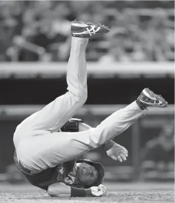  ?? JULIO CORTEZ/THE ASSOCIATED PRESS ?? Blue Jay Munenori Kawasaki hits the deck after being hit by a pitch in the third inning. He stayed in the game.