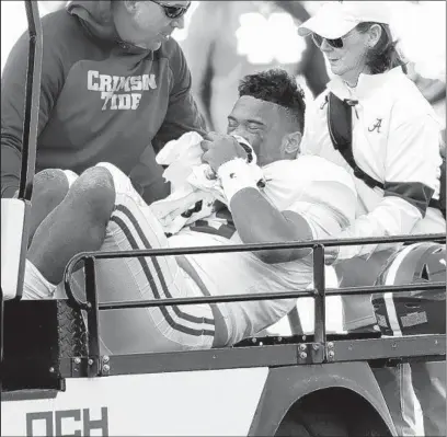  ?? ROGELIO V. SOLIS/AP ?? Alabama quarterbac­k Tua Tagovailoa is carted off the field after getting injured in the first half Saturday against Mississipp­i State.