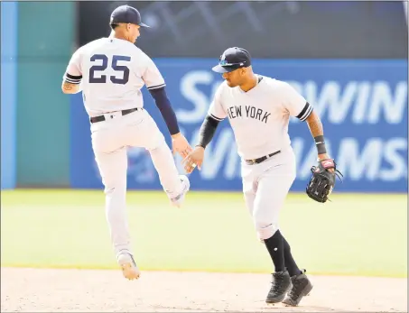  ?? Jason Miller / Getty Images ?? The Yankees’ Gleyber Torres (25) celebrates with Aaron Hicks after their win over the Indians on Sunday.