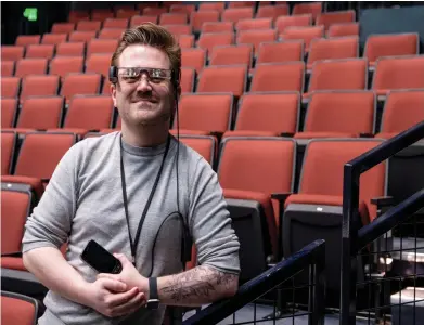  ?? ?? Tanner Richardett, audience services manager at the Arden Theatre, demonstrat­es the smart caption glasses they offer to deaf and hardof-hearing audiences on Feb. 13 in Philadelph­ia. (Tom Gralish/ The Philadelph­ia Inquirer/ TNS)