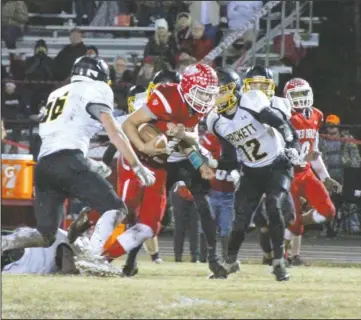  ?? The Sentinel-Record/Jami Smith ?? MOVING ON: Mountain Pine quarterbac­k Collin Smith (2) runs against Hackett’s Cooper Shipman (12) Friday during the Red Devils’ 35-26 playoff victory at Stanley May Field.