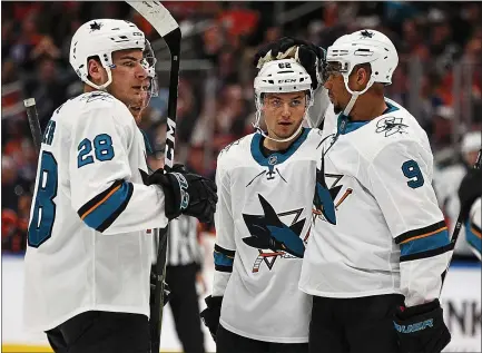  ?? PHOTOS BY IAN KUCERAK — POSTMEDIA ?? The Sharks’ Kevin Labanc, center, celebrates one of his three goals with teammates in a 5-2 thumping of the host Edmonton Oilers on Saturday.