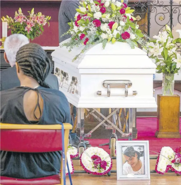  ??  ?? A photo of Latoya Monte, who was shot dead in Jamaica in June, allegedly during a confrontat­ion with the police, rests beneath the coffin bearing her body during her funeral service at St Clement’s Church in West London last year.