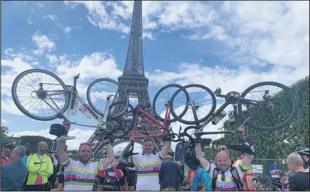  ??  ?? ■ Paul Riley, Nick Dimblebee and Adam Higgins celebrate in Paris after their cycle ride from London for Rainbows Hospice.