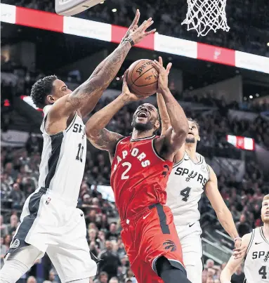  ?? ERIC GAY THE ASSOCIATED PRESS ?? Spurs guard DeMar DeRozan blocks a shot by Raptors forward Kawhi Leonard on Thursday night in San Antonio.