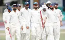  ?? — Reuters ?? India’s captain Virat Kohli celebrates with team-mates after winning the match.